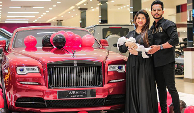 Amjad Sithara and wife Marjana pose in front of the luxury car with their baby Ayra Malika